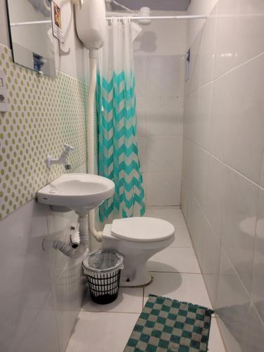 y baño con aseo, lavabo y ducha. en Hostel Margo, en Natal