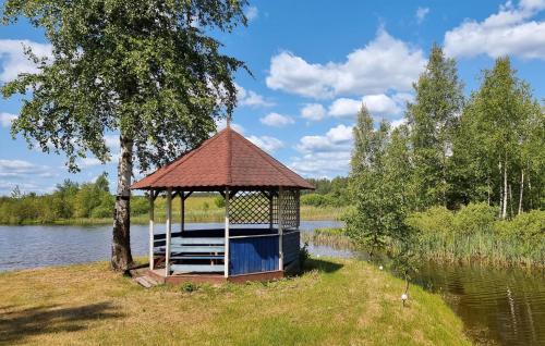 a gazebo on the side of a lake at 7 Bedroom Lovely Home In Szalstry in Szałstry