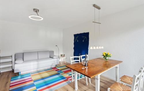 a living room with a table and a couch at Pet Friendly Apartment In Meschede With Kitchen in Meschede