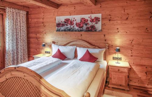 a bedroom with a bed in a wooden wall at Amazing Apartment In Brandenberg With Wifi in Brandenberg