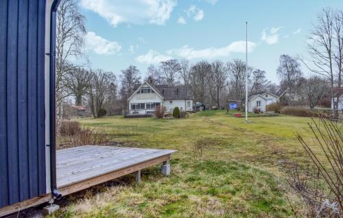 a wooden bench sitting on the side of a house at Gorgeous Home In Sturkö With Kitchen in Sturkö