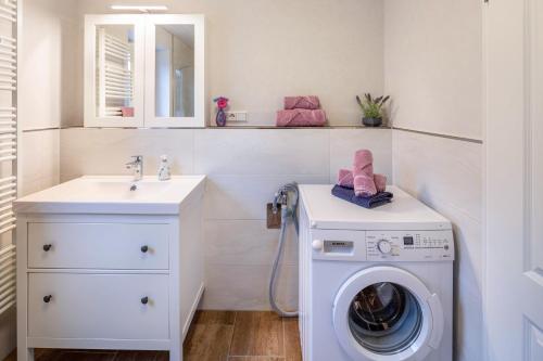 a bathroom with a washing machine and a sink at Ferienwohnung Haseltal in Rotenburg an der Fulda