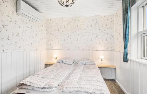 a bed in a bedroom with white walls at Lovely Home In Bogense With Wifi in Bogense