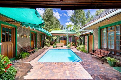 a swimming pool in the backyard of a house at Kleine Eden Guesthouse in Bloemfontein