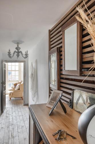 a room with a table with a mirror and a couch at YourHouse A Casa Dos Cregos in Fonteita