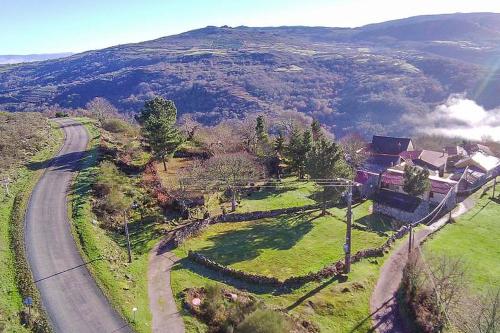 an aerial view of a house on a hill with a road at YourHouse A Casa Dos Cregos in Fonteita