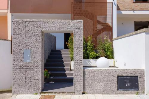 a staircase leading to a building with a doorway at Le dimore di Calù in San Donato di Lecce