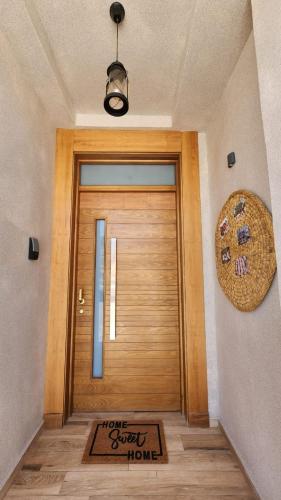 a wooden door with a sign that reads home sweet home at Edy's STD03 in Imsouane