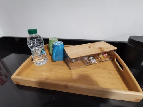 a wooden tray with a bottle of water on it at Edy's STD03 in Imsouane