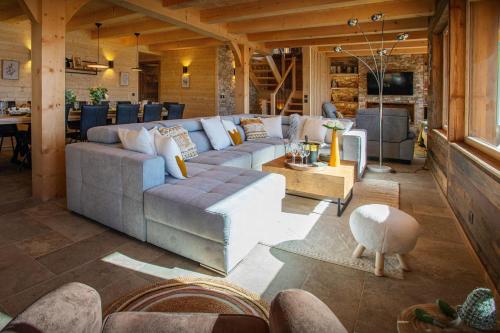 a living room with a couch and a table at Chalet Serbijanka - OVO Network in Manigod