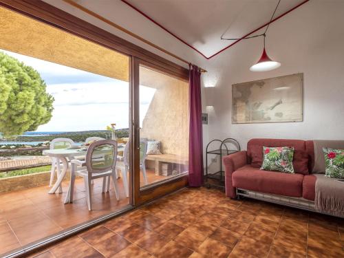 a living room with a couch and a table at Apartment I-1-4 by Interhome in Golfo Aranci