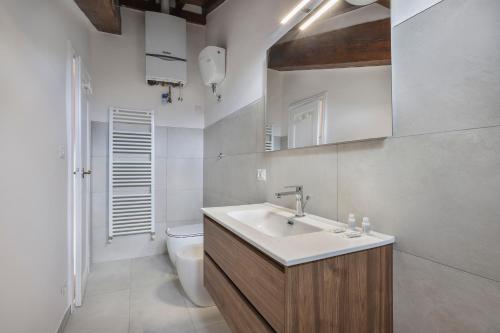 a bathroom with a sink and a toilet at Palazzo Borghese Apartment with Panoramic Terrace in Florence