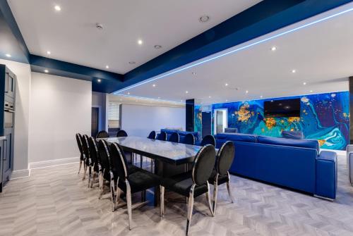a dining room with a table and chairs and an aquarium at Temple Court Cavern Quarter Apartments in Liverpool