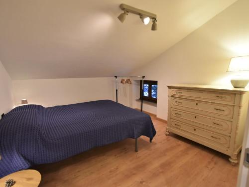 a bedroom with a bed and a dresser and a window at Apartment Guanella Apartment by Interhome in Campodolcino