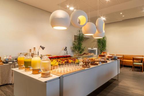 a buffet line with fruits and drinks on it at Lifestyle Laghetto Collection in Rio de Janeiro