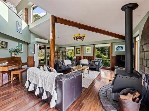 a large living room with a wood burning stove at Pemberton Forest View Retreat in Pemberton