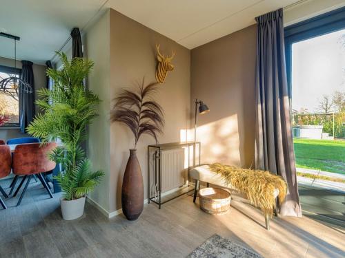 a living room with potted plants and a couch at Holiday Home Vip Wellness Ewijk by Interhome in Ewijk