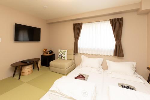 a hotel room with two beds and a window at Light Hotel - Vacation STAY 17218v in Tokyo