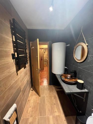 a bathroom with a sink and a mirror at Mountain Lodge T3 Duplex Abrigo do Lobo in Covilhã
