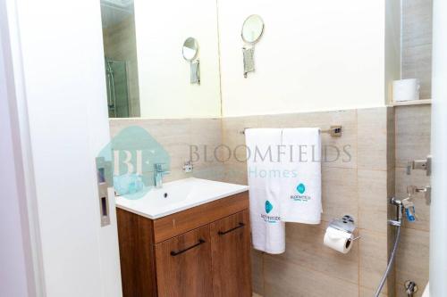 uma casa de banho com um lavatório e um espelho em Iconic Studio In Oasis em Abu Dhabi