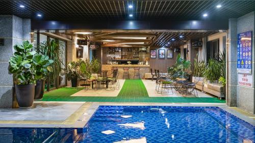 een zwembad in het midden van een gebouw met een bar bij Cat Ba Paradise Hotel- Pool & Sky Bar in Cat Ba