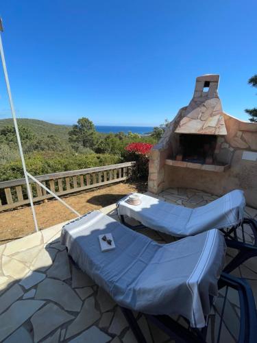 a patio with a table and a brick oven at Résidence U Pirellu in Porto-Vecchio