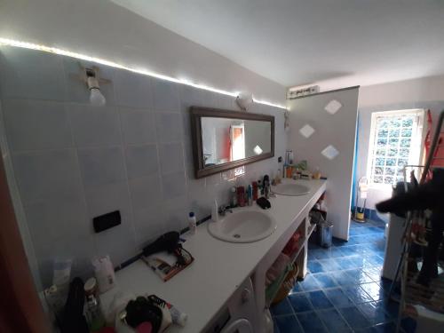 Baño con 2 lavabos y espejo en la pared en Casa belvedere en Sanfront