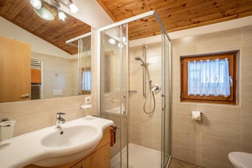 a bathroom with a sink and a shower at Speckign Apartment 3 in Cadipietra