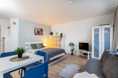 a bedroom with a bed and a living room at Passion Fruit Apartment Pge Narodowy in Warsaw
