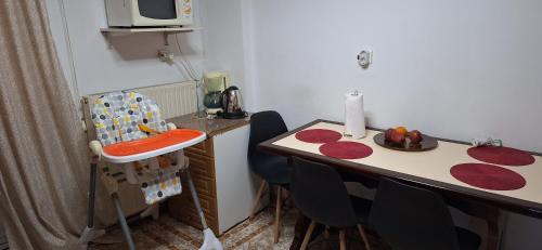 a small kitchen with a table and chairs and a counter at HARMA cozy apartment in Athens