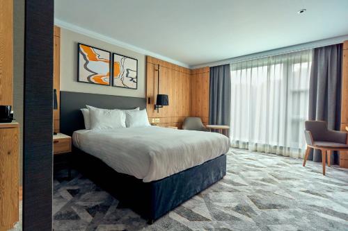 a hotel room with a bed and a desk at Crowne Plaza Marlow by IHG in Marlow