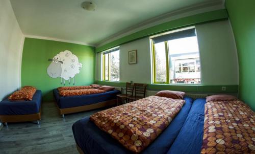 a bedroom with two beds and a window at Selfoss Hostel in Selfoss