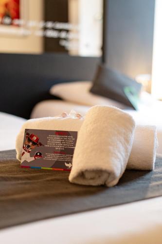 a roll of paper towels sitting on a table at Logis Hôtel Des Acacias Lille Neuville en Ferrain, Restaurant l'Acacias Gourmand in Neuville-en-Ferrain