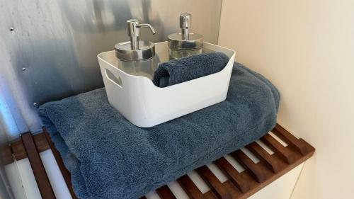 a bathroom with a blue towel and two faucets at Airstream Experience in Knutsford