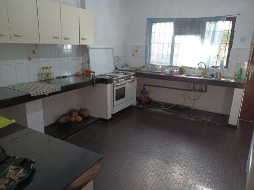 a kitchen with a sink and a stove top oven at 67 holiday home in Badulla