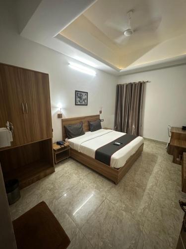 a bedroom with a large bed in a room at Gulnaar Inn in Chennai