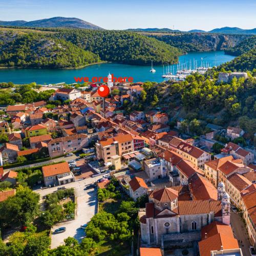 an aerial view of a small town next to a body of water at Mediterranean terrace apartment with Bikes & SUP in Skradin