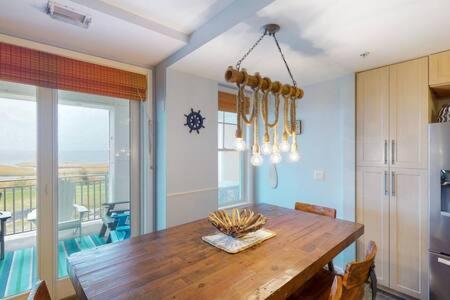 a dining room with a wooden table and a dining room at Sojourn Penthouse Sanctuary Condo 4 BR in Virginia Beach