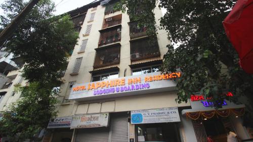 a building with a sign on the side of it at HOTEL SAPPHIRE INN in Thane