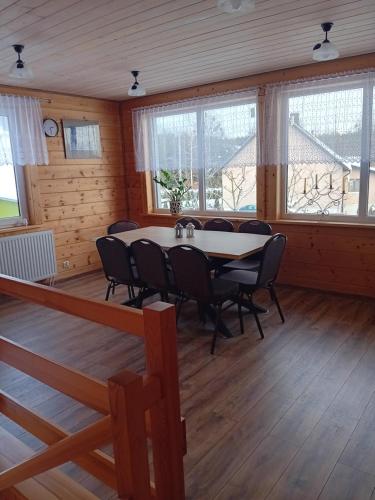 a dining room with a table and chairs at SZUMI LAS in Białowieża