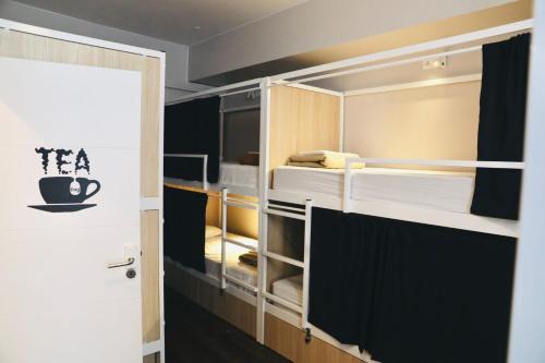 a room with a cupboard with some beds at Gspot Hostels & Love Triangles Pizzeria in Lisbon