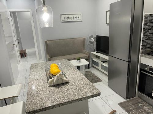 a kitchen with a counter top and a refrigerator at Charming Apt Mindelo in Mindelo