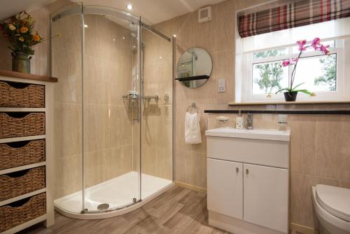 a bathroom with a shower and a sink at Dryburgh Steading Two in Saint Boswells