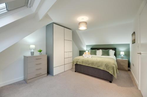 a white bedroom with a bed and a dresser at Charltons Bonds 2A Stylish Staycation City Break in Newcastle upon Tyne