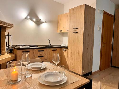 a kitchen with a table with plates and wine glasses at Alloggio Aquila d'Oro in Creazzo