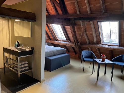 a bedroom with a bed and a table and chairs at Den Eijngel bed and breakfast in Boxtel