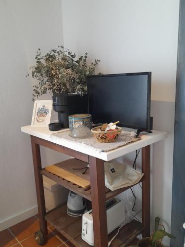 a desk with a television on top of it at Villa Oliva in Sanlúcar la Mayor