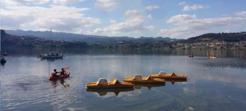 a group of people in boats on a lake at CASA DO AVÒ in Castrelo de Miño