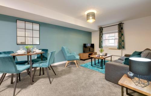 a living room with a couch and a table and chairs at Charltons Bonds 2A Stylish Staycation City Break in Newcastle upon Tyne