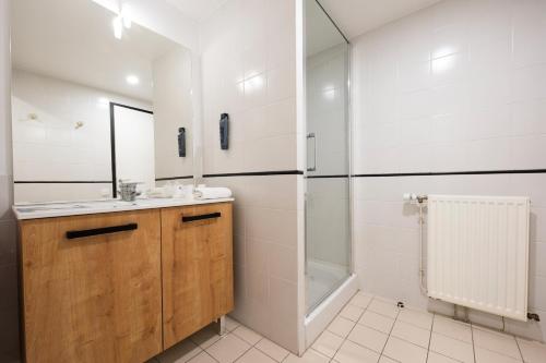 a bathroom with a sink and a shower at Azureva Ronce les Bains in Ronce-les-Bains